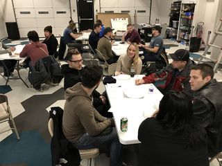 People working and discussing around tables