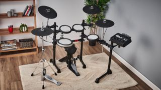 Yamaha DTX6 electronic drum set with TCS heads on a rug on a wooden floor