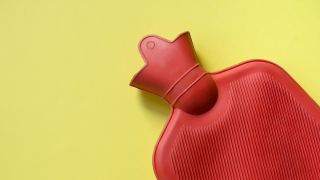 red hot water bottle on yellow background