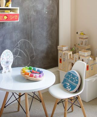 kids bedroom with chalk board wall and retro table and chair