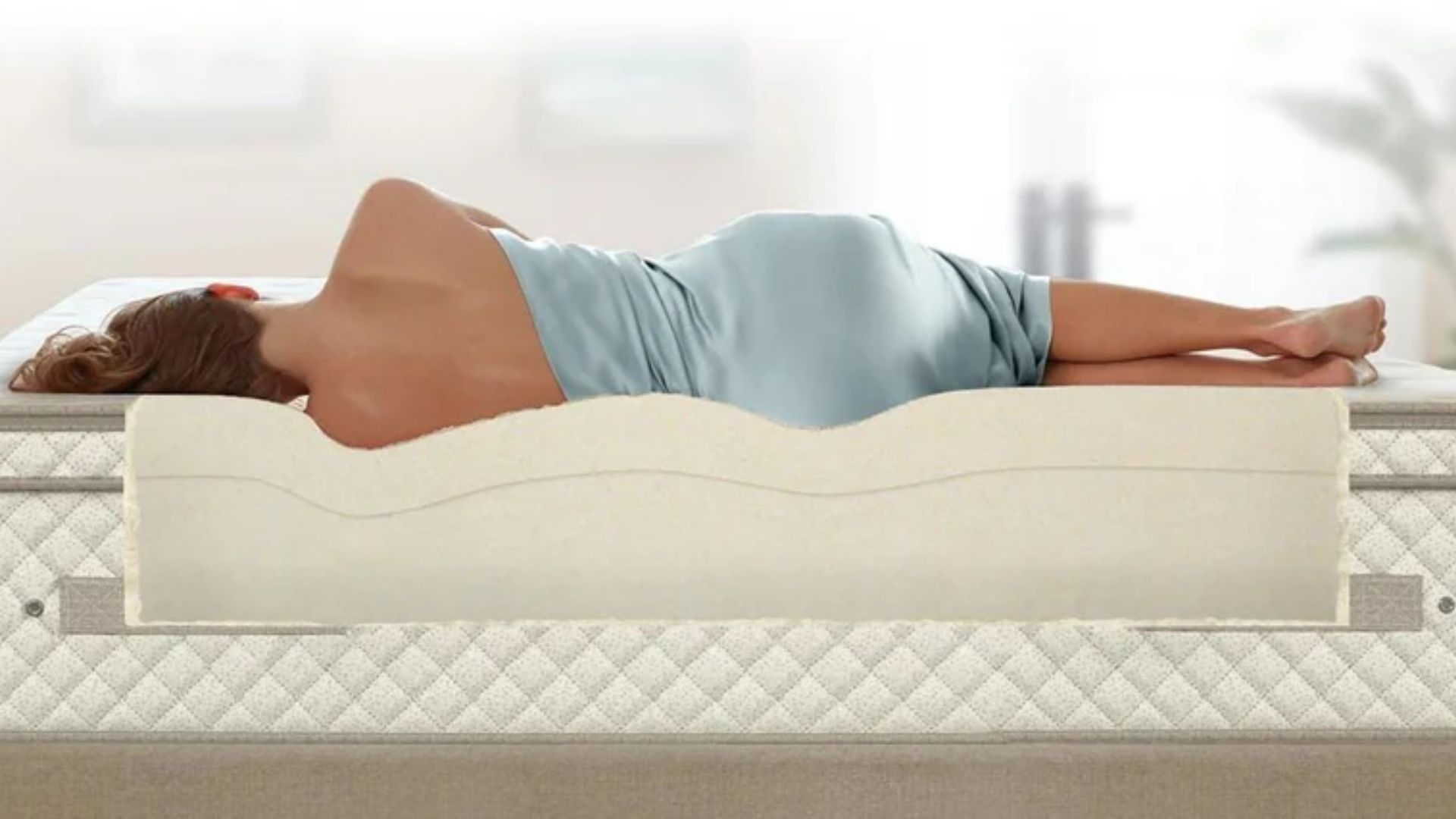 The back angle of a woman sleeping on her side on the Plushbeds botanical bliss with the layers inside the mattress visible