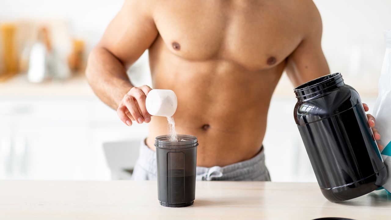 Man scooping protein powder