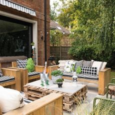 garden patio with pallet table and wood furniture