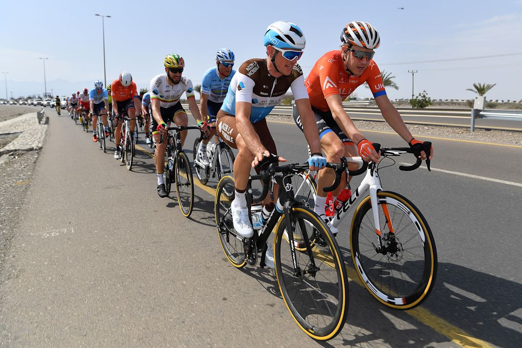 Rob Britton rides alongside Mathias Frank at the head of the 2019 Tour of Oman peloton