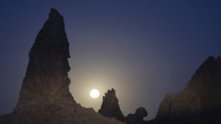 The Strawberry Supermoon sets behind the Trona Pinnacles in California's Mojave Desert.