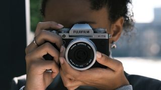 Fujifilm X-T5 being held by photographer in front of her face