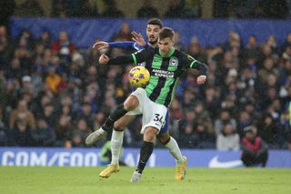 LONDON, ENGLAND - DECEMBER 3: Joel Veltman of Brighton & Albion clears the ball being pressed by Armando Broja of Chelsea during the Premier League match between Chelsea FC and Brighton & Hove Albion at Stamford Bridge on December 3, 2023 in London, England. (Photo by MB Media/Getty Images)