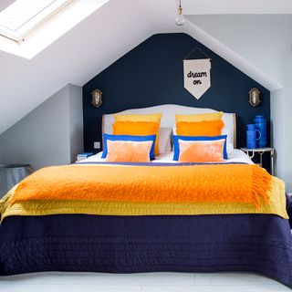 attic bedroom with bed and blue jars