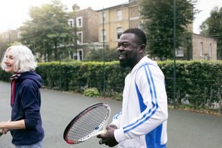 Man and woman playing tennis as lockdown restrictions lift in England