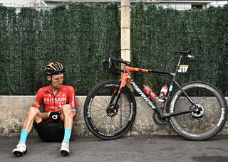 Bahrain Victorious teams Australian rider Jack Haig rests on the sidewalk next to his bicycle after a fall during the 5th stage of the 109th edition of the Tour de France cycling race 1537 km between Lille and Arenberg Porte du Hainaut in northern France on July 6 2022 Photo by Marco BERTORELLO AFP Photo by MARCO BERTORELLOAFP via Getty Images