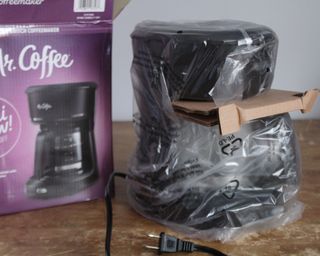 Mr. Coffee 5-cup mini brew coffee maker in plastic packaging