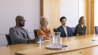 Carl Clemons-Hopkins, Jean Smart, Paul W. Downs, Hannah Einbinder at a conference table in Hacks