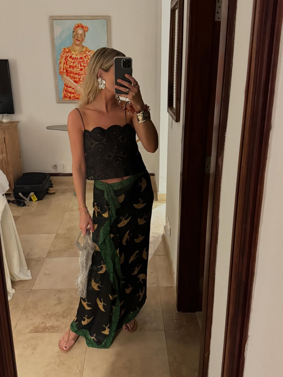Influencer Lucy Williams wearing broderie anglaise top, printed skirt and statement earrings.