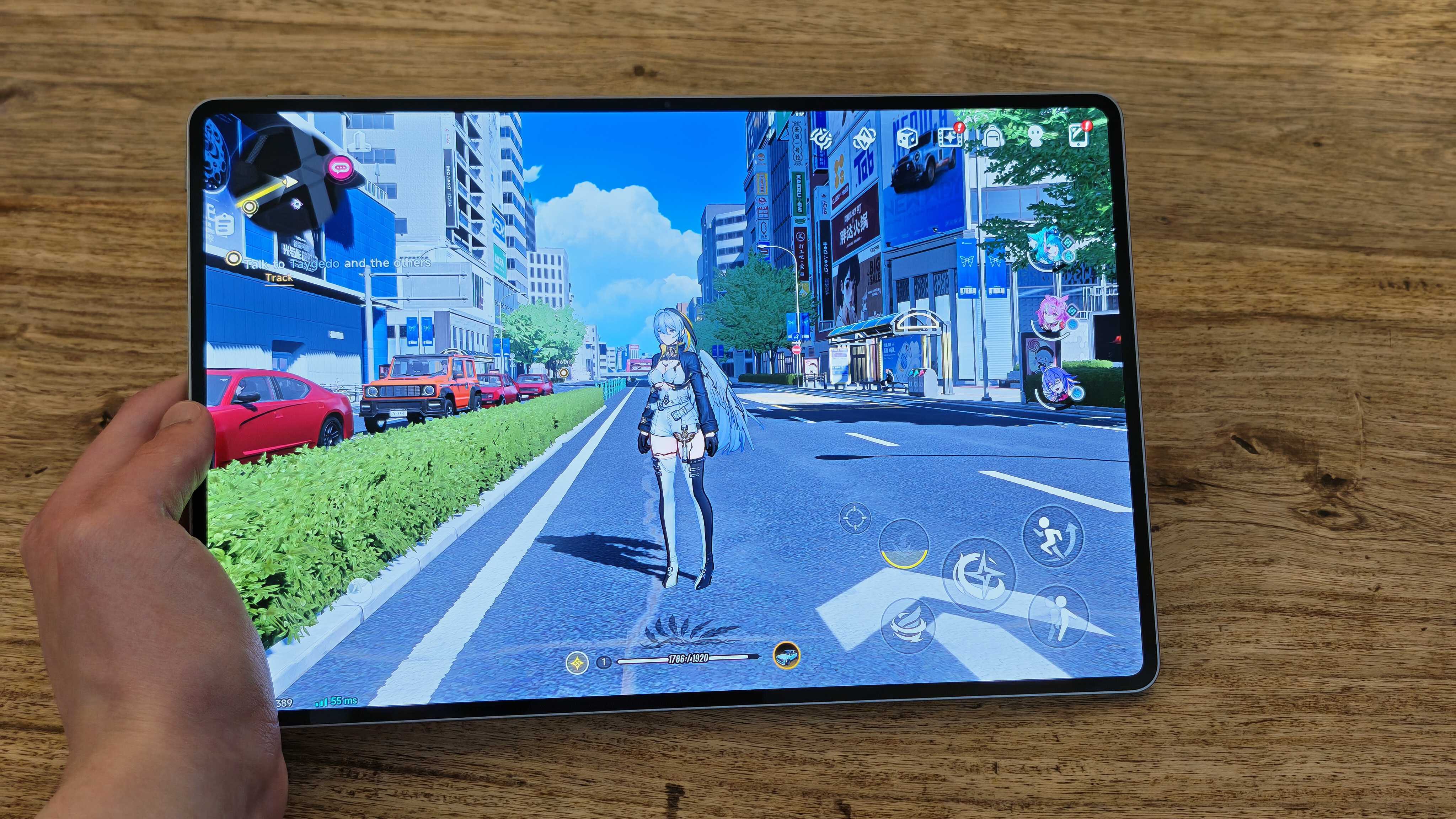 A photograph of the Honor MagicPad 4 in use on a wooden table.