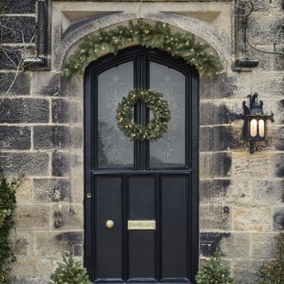 Garland around top of black door