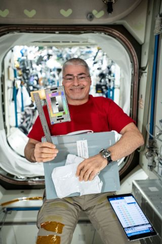 NASA astronaut Mark Vande Hei, as seen in February 2021 holding the tools for an archeology study aboard the space station.