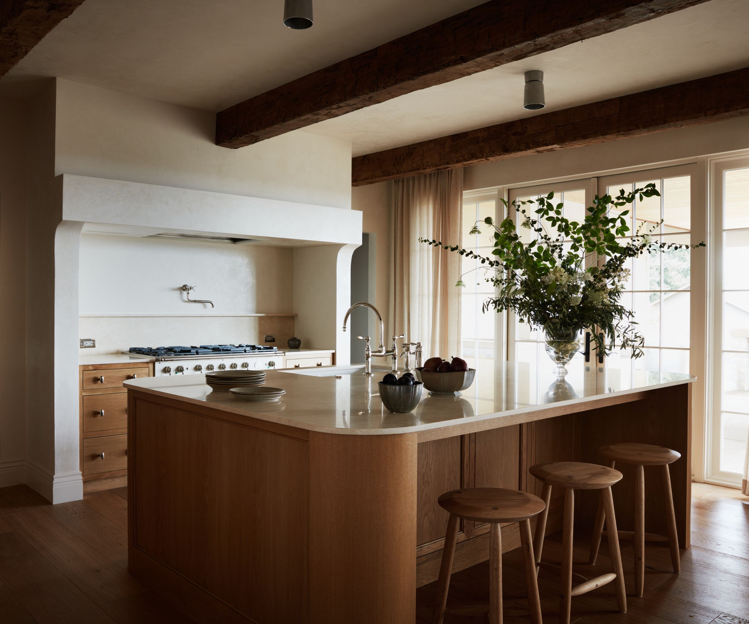 A wooden kitchen with a curved island