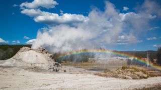 Rainbow in steam over geyser at Yellowstone National Park, Wyoming, UISA