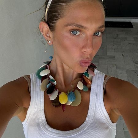 Woman in white tank and bold summer necklace