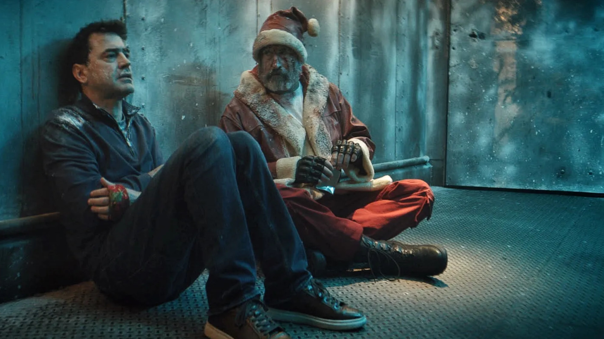 Ron Livingston as Mark and Rob Riggle as Santa in the upcoming horror movie, Christmas at the Kringles