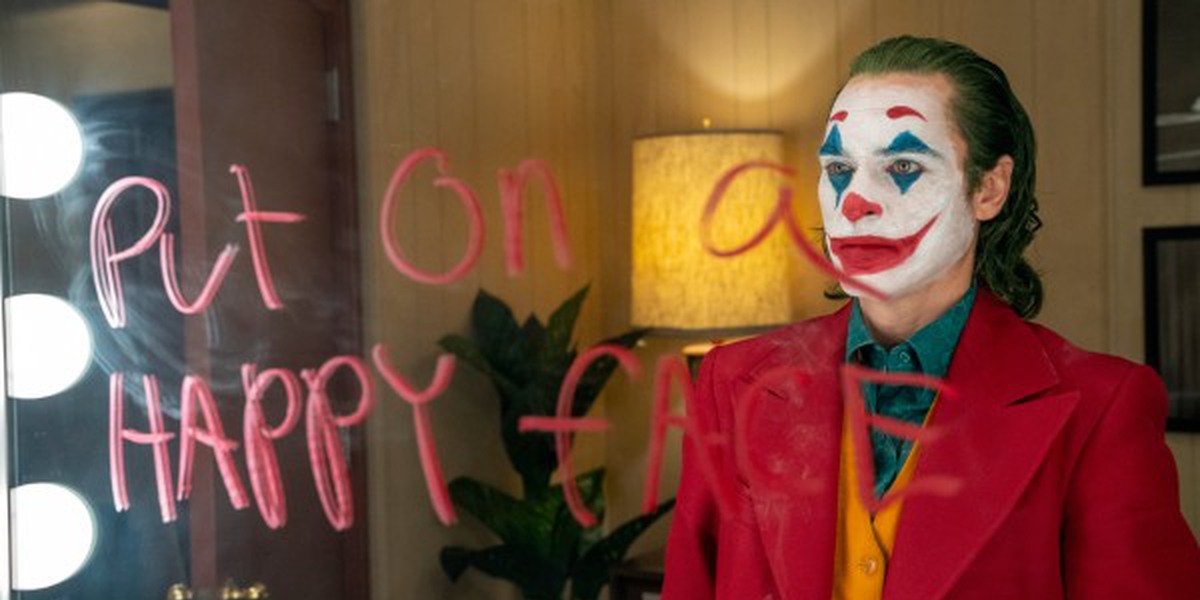 Joaquin Phoenix in Joker Put On A Happy Face written on mirror