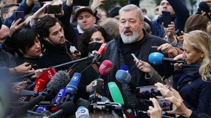 Dmitry Muratov speaks to reporters after winning the Nobel Peace Prize.