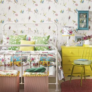 bedroom with bird wallpaper and flower vase