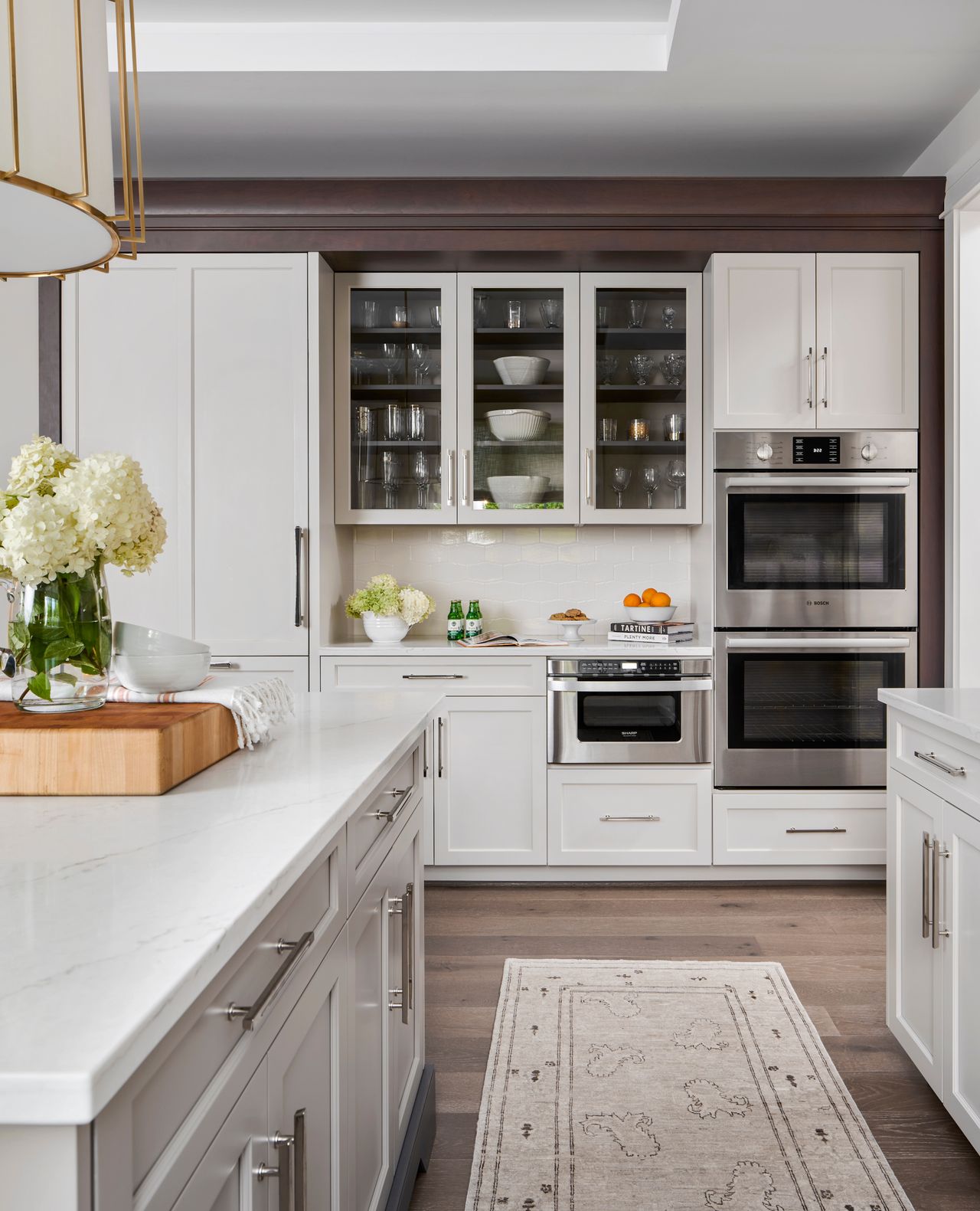white kitchen with wooden floor and cream rug