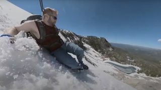 Man sliding down snowy mountain