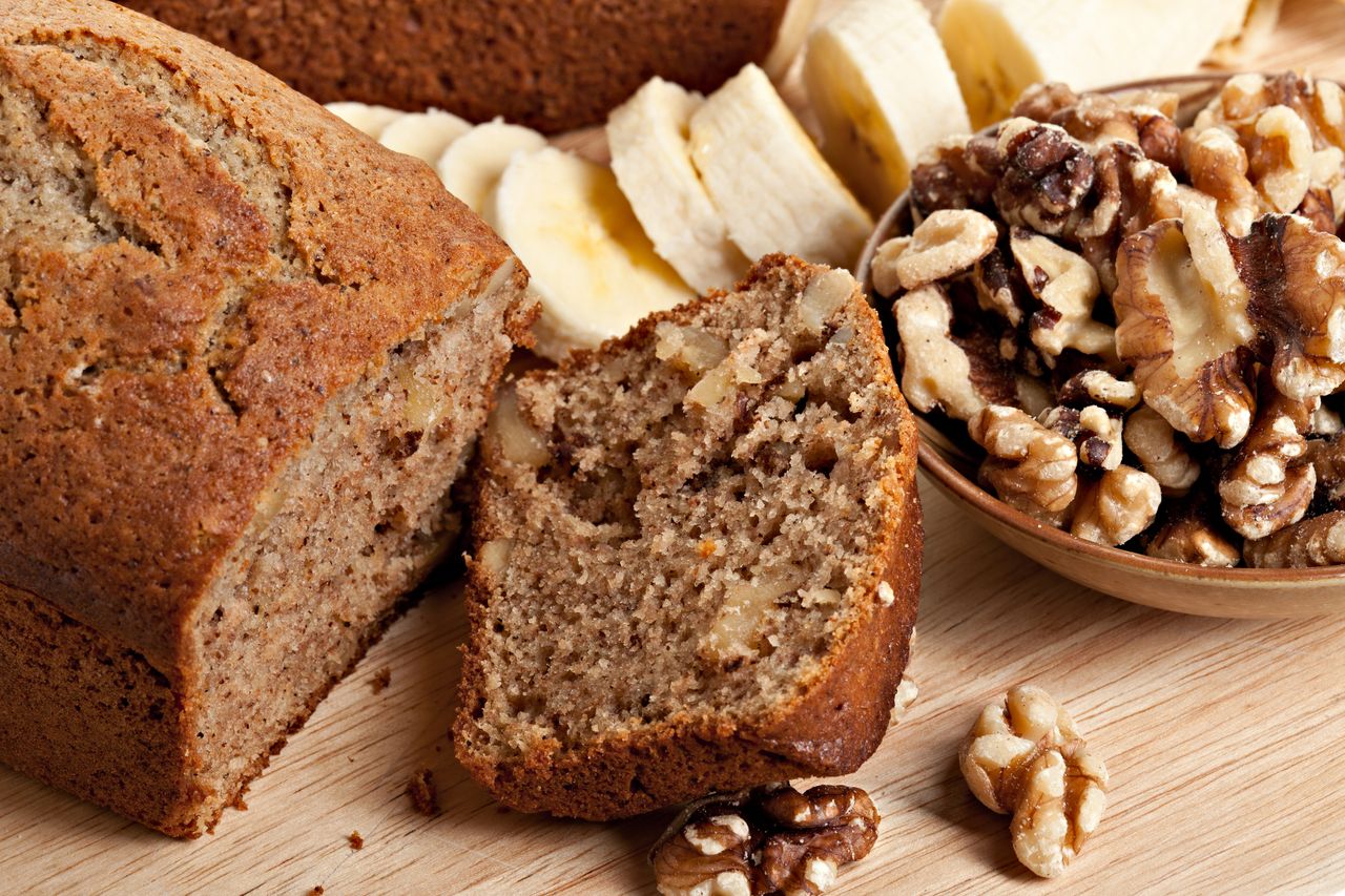 Close up of banana walnut bread with walnuts and freshly cut banana