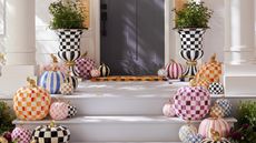 Front door with colourful striped and chequered pumpkins on steps