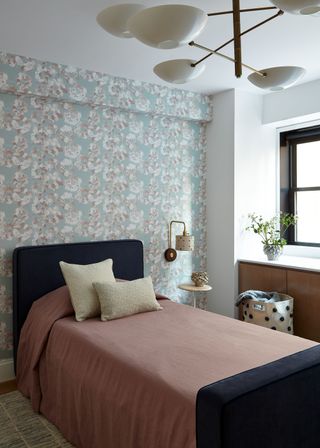 kids room with single bed, wallpaper and windowstill with plant