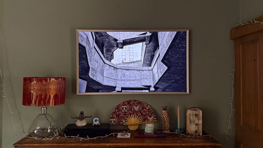 The Samsung Frame TV above a wooden book case.