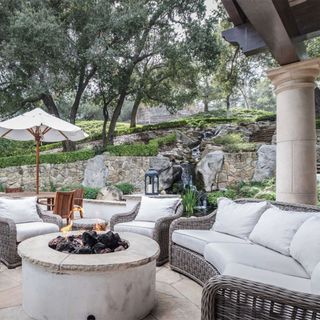 outdoor area with cane sofa set and fire pit