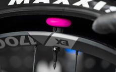 The Muc-Off Stealth AirTag holder installed on bike wheel, showing how the product works