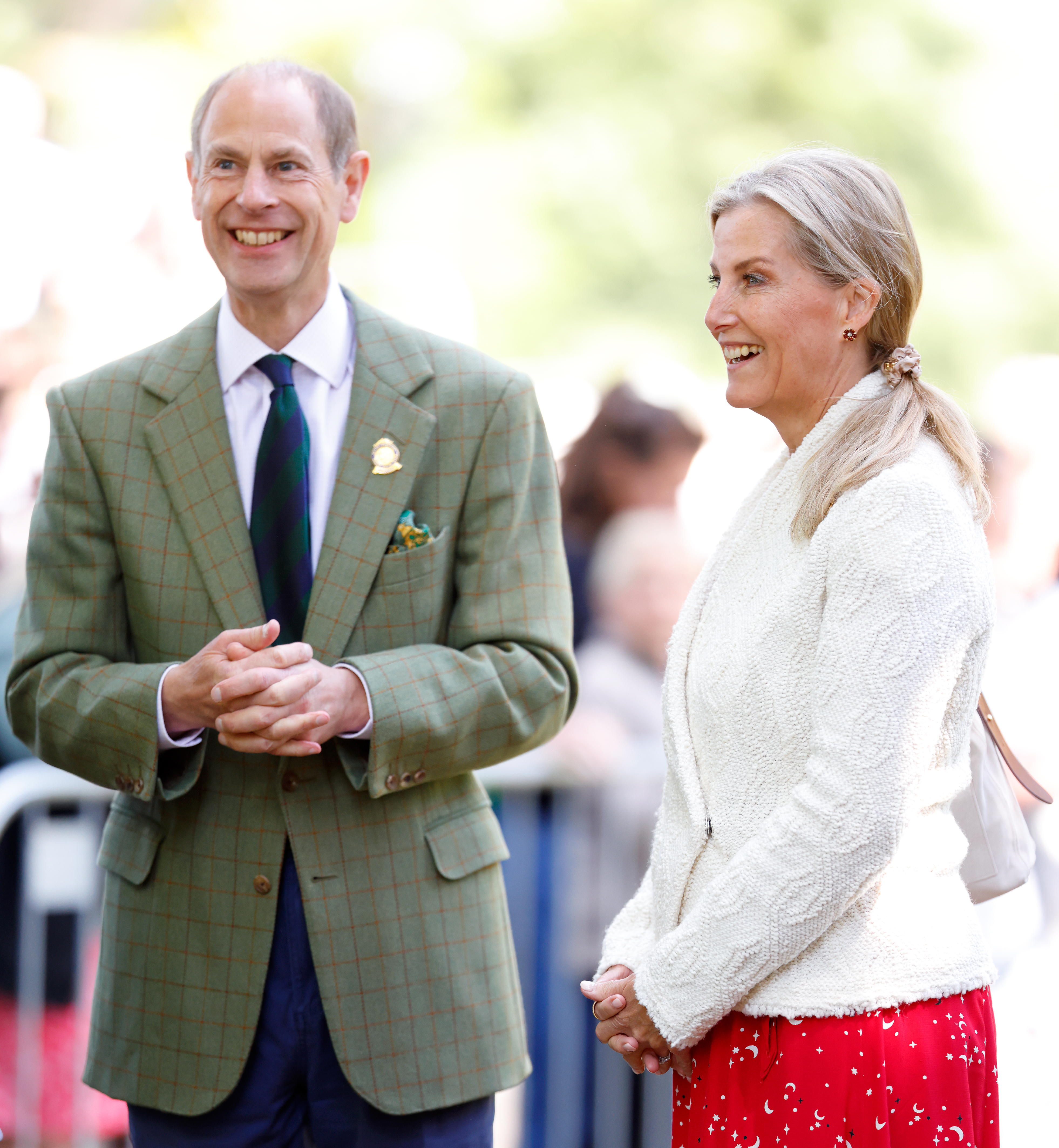 Duchess sophie and Prince Edward standing next to each other, wearing blazers and smiling