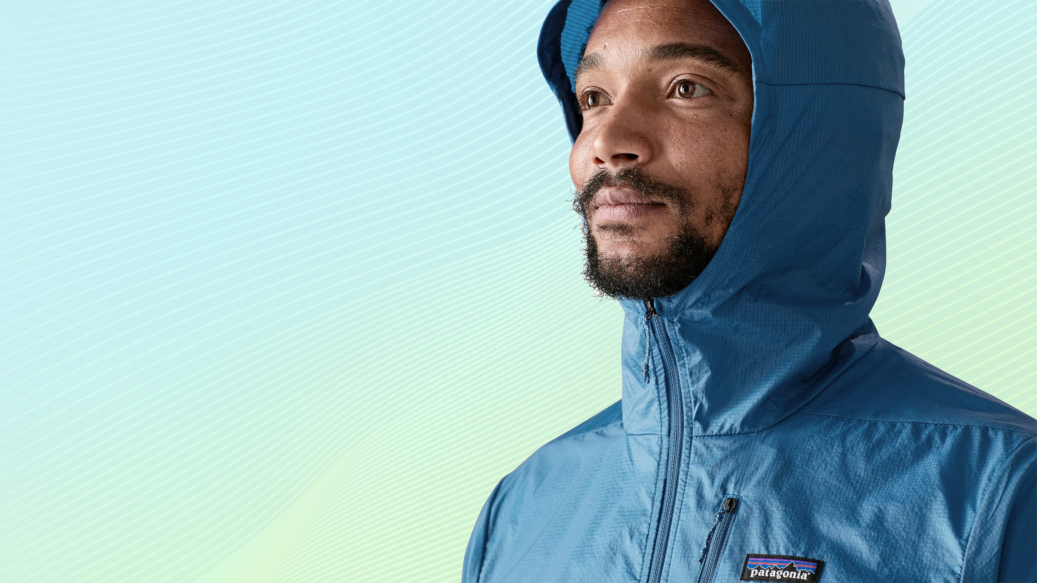 Close-up of a model wearing the Patagonia Houdini in blue