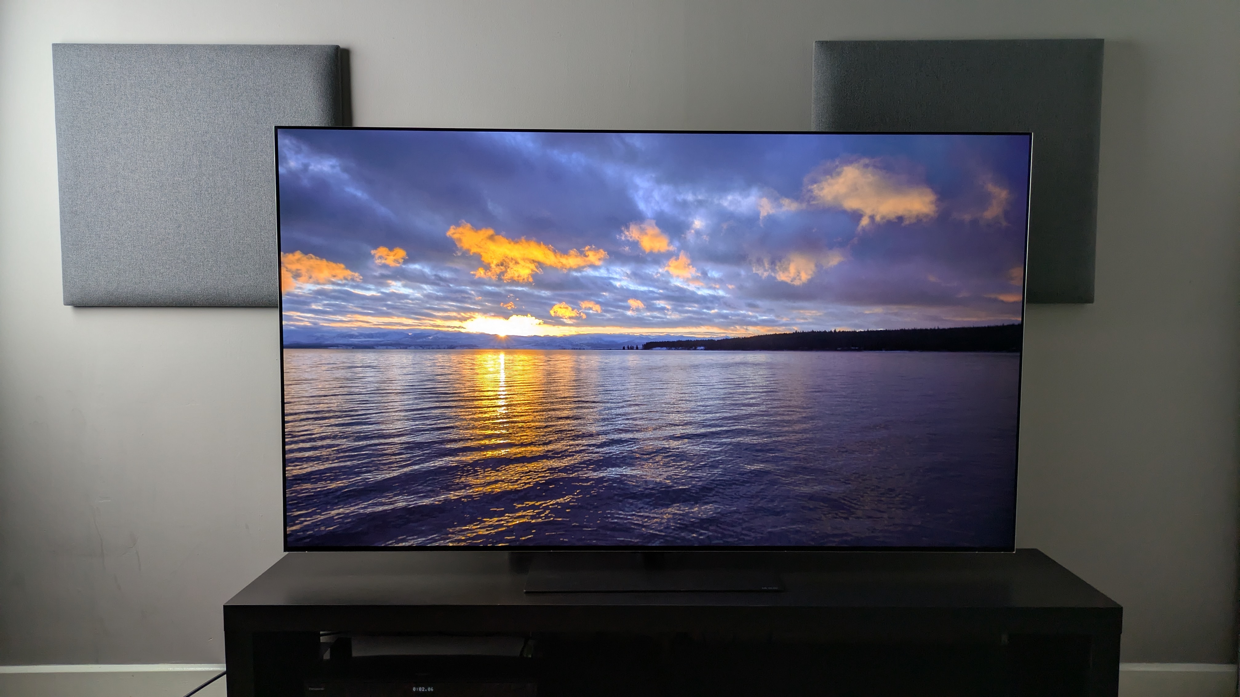 LG G6 OLED TV showing a sunset over a lake on screen. Demonstrates the G6's strong contrast and punchy peak highlight