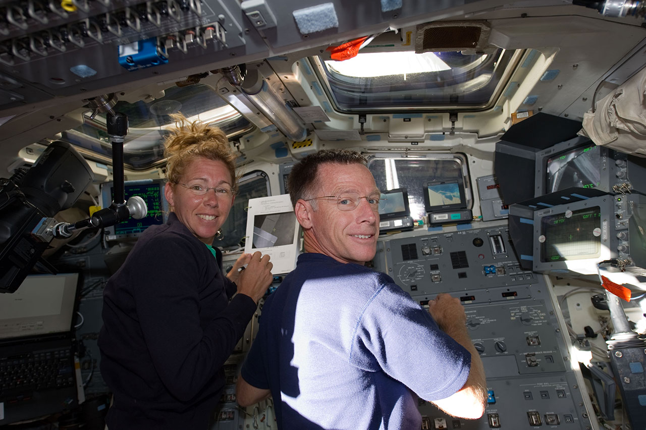 2022 Astronaut Hall of Fame inductees Sandy Magnus and Chris Ferguson, as seen on on the aft flight deck of the space shuttle Atlantis during the final space shuttle mission, STS-135.