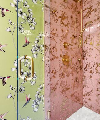 Pink and gold shower interior next to lime green floral wallpaper