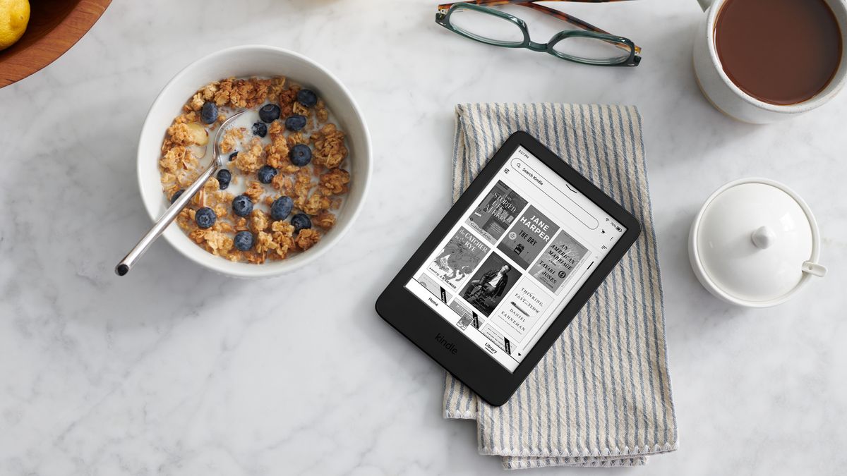 Amazon Kindle (2022) on a table next to a bowl of cereal