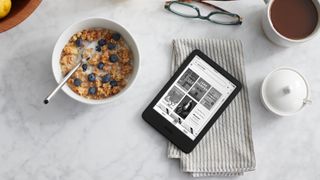 Amazon Kindle (2022) on a table next to a bowl of cereal