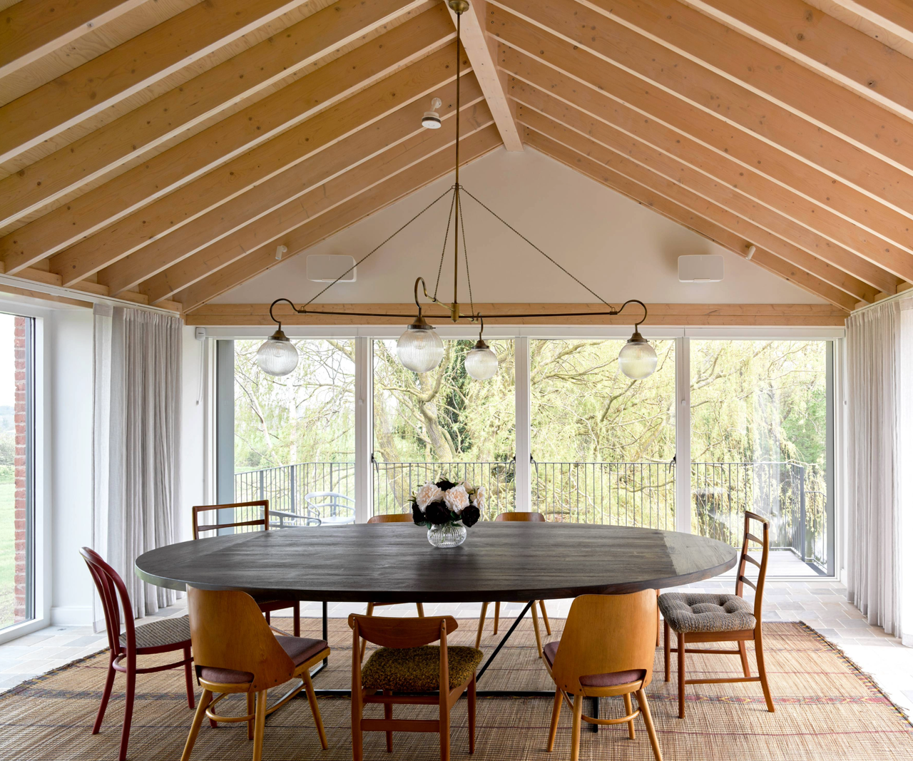 Dining area with vaulted ceiling and large windows on each wall