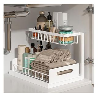 White two tier storage shelf with bathroom products arranged inside