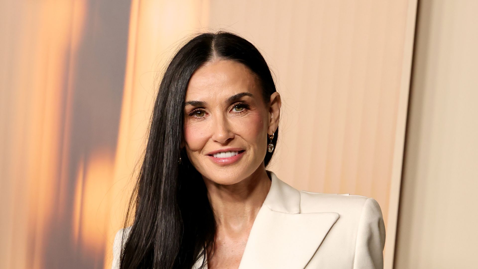 A HEADSHOT OF DEMI MOORE WEARING WHITE 