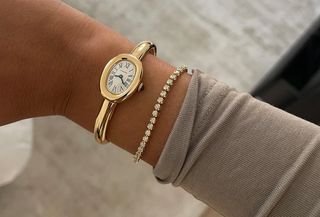 Nicole Akhtarzad wearing a gold Cartier Baignoire watch with a diamond tennis bracelet