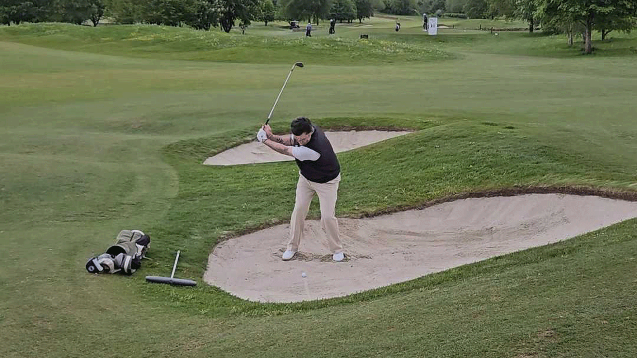 Joe Ferguson hits a bunker shot during a PGA event at Minchinhampton Golf Club
