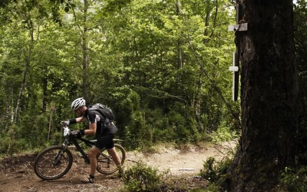A racer in a hike a bike section
