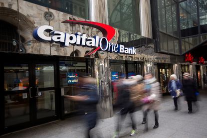 Pedestrians walking past a Capital One Bank location.