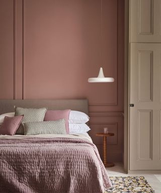 Pink walls and bedding, white hanging light